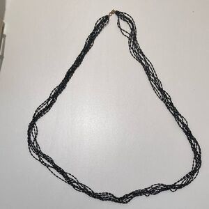 Black beaded 8 strand necklace.  Approx 48” total length